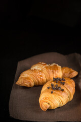 two croissants on a black background