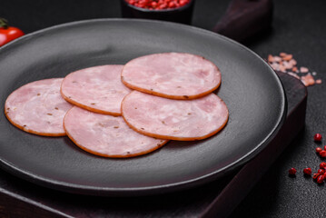 Delicious fresh ham cut into round slices with salt, spices and herbs