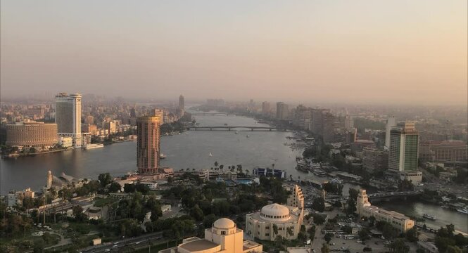 Cairo, Egyptpanoramic aerial sunset view of the Nile and downtown Cairo with traffic and boats seen from Cairo Tower - 29,Aug 2023.

