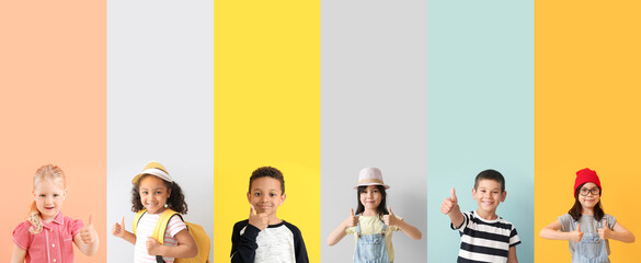 Collage of happy little children showing thumb-up gesture on color background