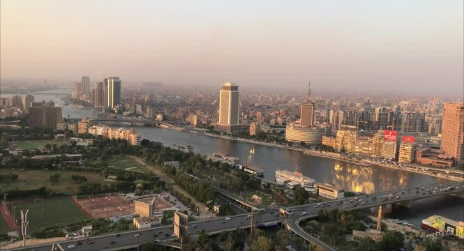 Cairo, Egyptpanoramic aerial sunset view of the Nile and downtown Cairo with traffic and boats seen from Cairo Tower - 29,Aug 2023.
