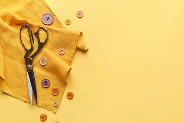 Fabric, scissors and different buttons on color background