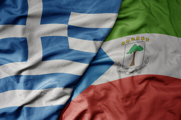 big waving national colorful flag of greece and national flag of equatorial guinea .