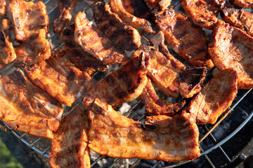 Cooking tasty tenderloin meat slices at bbq grill backyard. grilling on charcoal. steaks on the grill. Roasting meat on metal grid on hot charcoal. Grilling barbeque meat outdoors