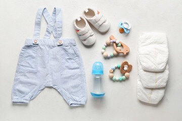 Composition with baby accessories and clothes on light background