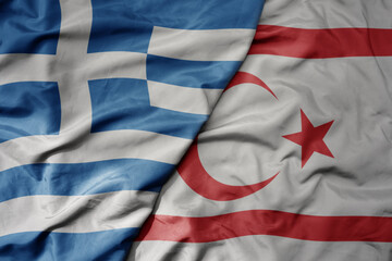 big waving national colorful flag of greece and national flag of northern cyprus .