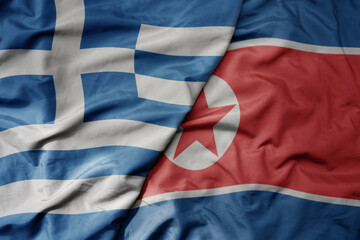 big waving national colorful flag of greece and national flag of north korea .