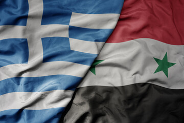 big waving national colorful flag of greece and national flag of syria .