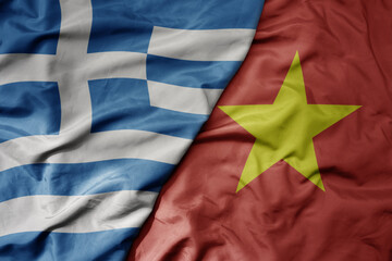 big waving national colorful flag of greece and national flag of vietnam .