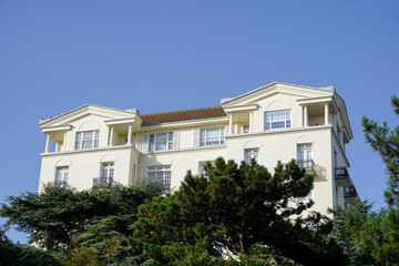Fototapeta na wymiar Luxury apartments in elegant white building on hilltop. 