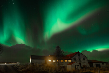 Northern Light,  spectacular Aurora borealis over a farm in Iceland