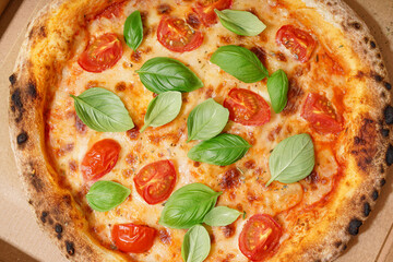 Tasty pizza Margarita with tomatoes and basil, closeup