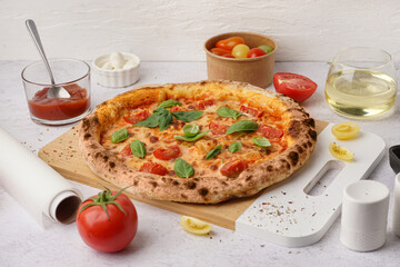 Board of tasty pizza Margarita with basil on white table