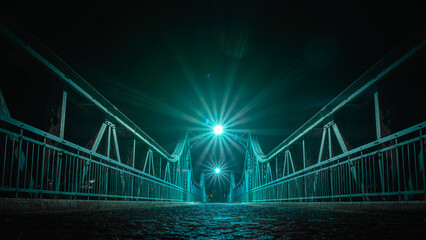 Wroclaw, the Bartoszowicki bridge, a metal structure illuminated at night, enabling crossing to the other bank of the Odra River.