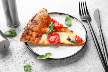 Plate with slice of tasty pizza Margarita on grey background