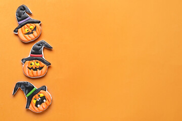 Tasty cookies in shape of pumpkin for Halloween celebration on beige background