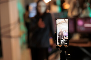 Masked hacker broadcasting live video to ask for ransom, hacking computer system password and breaking into online server. Anonymous thief attacking database and stealing information.