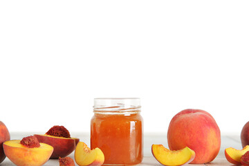 Jar with sweet peach jam and fresh fruits on table