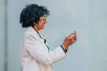 middle-aged woman walking looking at mobile phone