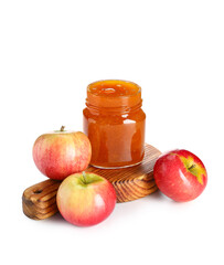 Wooden board with jar of sweet apple jam on white background