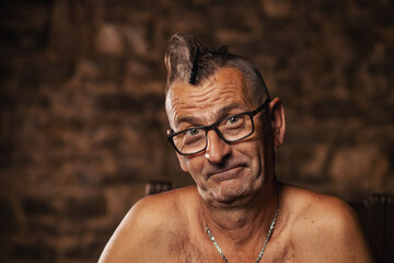 Fototapeta na wymiar An older man, a pensioner, wearing glasses with a mohawk. Serbian nationality, happy face.