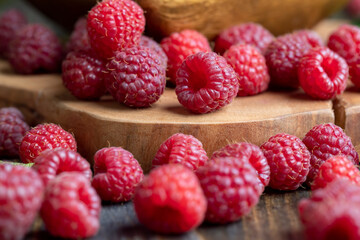 Ripe raspberries on a wooden board