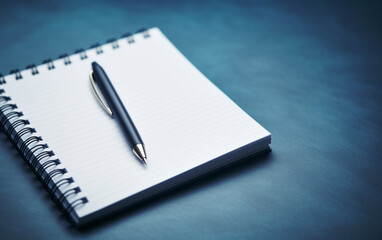 Notepad on a table with pen before meeting, blue tone, business concept with copy space
