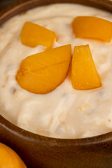fresh cow's milk yogurt with peach slices, dairy yogurt