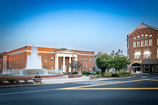 City center fountain and the Pulaski County government office in Somerset, Kentucky, during the morning hours under a clear sky. 