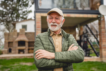 One senior man stand outdoor in front of his house happy confident