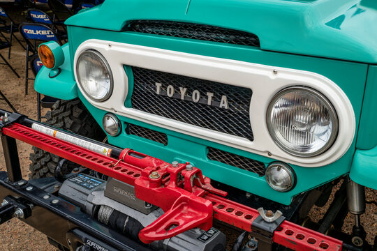 Loveland, CO, USA - August 26, 2023: Front and grille of of beautifully restored vintage Toyota Land Cruiser with a modern bumper, winch, and high lift jack.