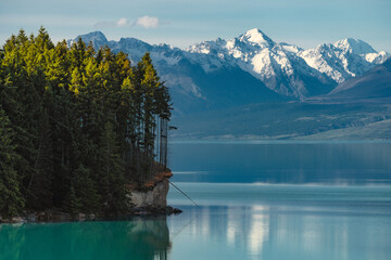 Lake at sunset surrounded by snow capped mountains
