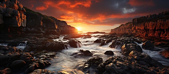 Dramatic and peaceful image of a sunset over a rocky shore AI Generated