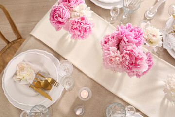 Stylish table setting with beautiful peonies and burning candles, flat lay