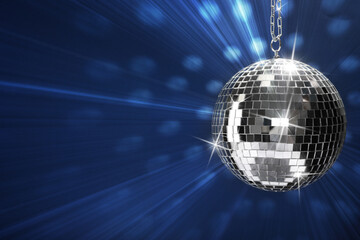 Fototapeta premium Shiny bright disco ball on blue background, space for text