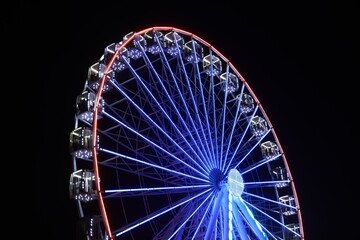 Beautiful glowing Ferris wheel against dark sky