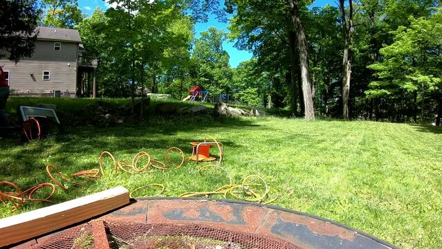 time-lapse woman trimming edges in garden with electric edge trimer in the spring