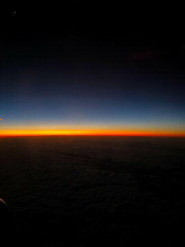 Sun setting over clouds in sky, Hawaii, USA
