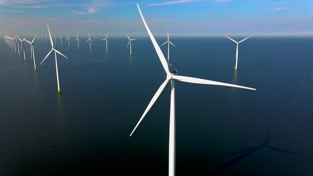 Windmill park with clouds and a blue sky, windmill park in the ocean aerial view with wind turbine Flevoland Netherlands Ijsselmeer