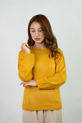 Excited Asian woman raising hands gesture on isolated background, promo advertisement concept Cheerful teenage girl in yellow shirt standing in white room