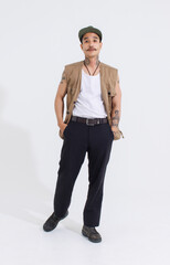 Portrait isolated cutout studio full body shot Asian vintage classy mustache neck arms tattoos male fashion model in casual fashionable safari vest and cap standing look at camera on white background
