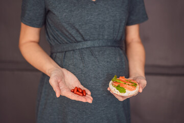 A thoughtful pregnant woman over 40 considering whether to eat fish or opt for omega 3 capsules for a nourishing and healthy pregnancy