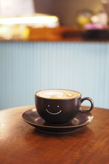 black coffee cup with smile shape design on it 