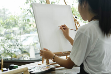 Crafting Inspiration: Female Artist Sketching and Painting in Workshop