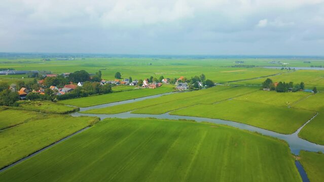 Dutch villages and houses in between polder grassland