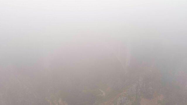 The Bixby Bridge on Big Sur's State Route-1 is barely visible through the thick fog