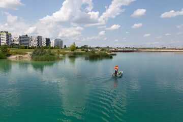 Fototapeta na wymiar A man is sailing on a boat on Lake Asperger in Vienna