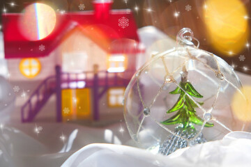 Winter and Christmas concept. Snow globe, doll house and fairy magic atmosphere, golden bokeh