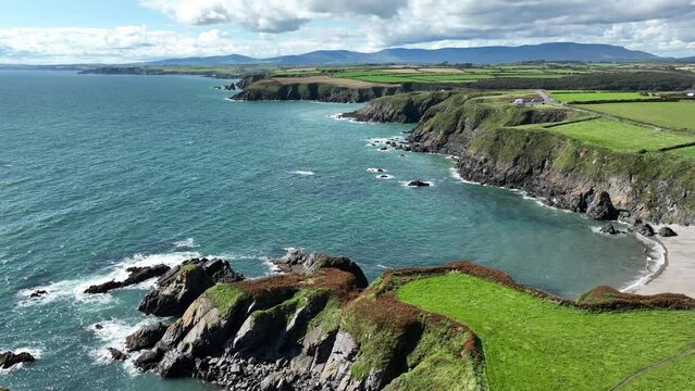 Coast Ireland dramatic sea cliff and sheltered beach with coverage Mountains Copper Coast Waterford