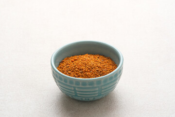 Dried red chilli powder on bowl, copy space
